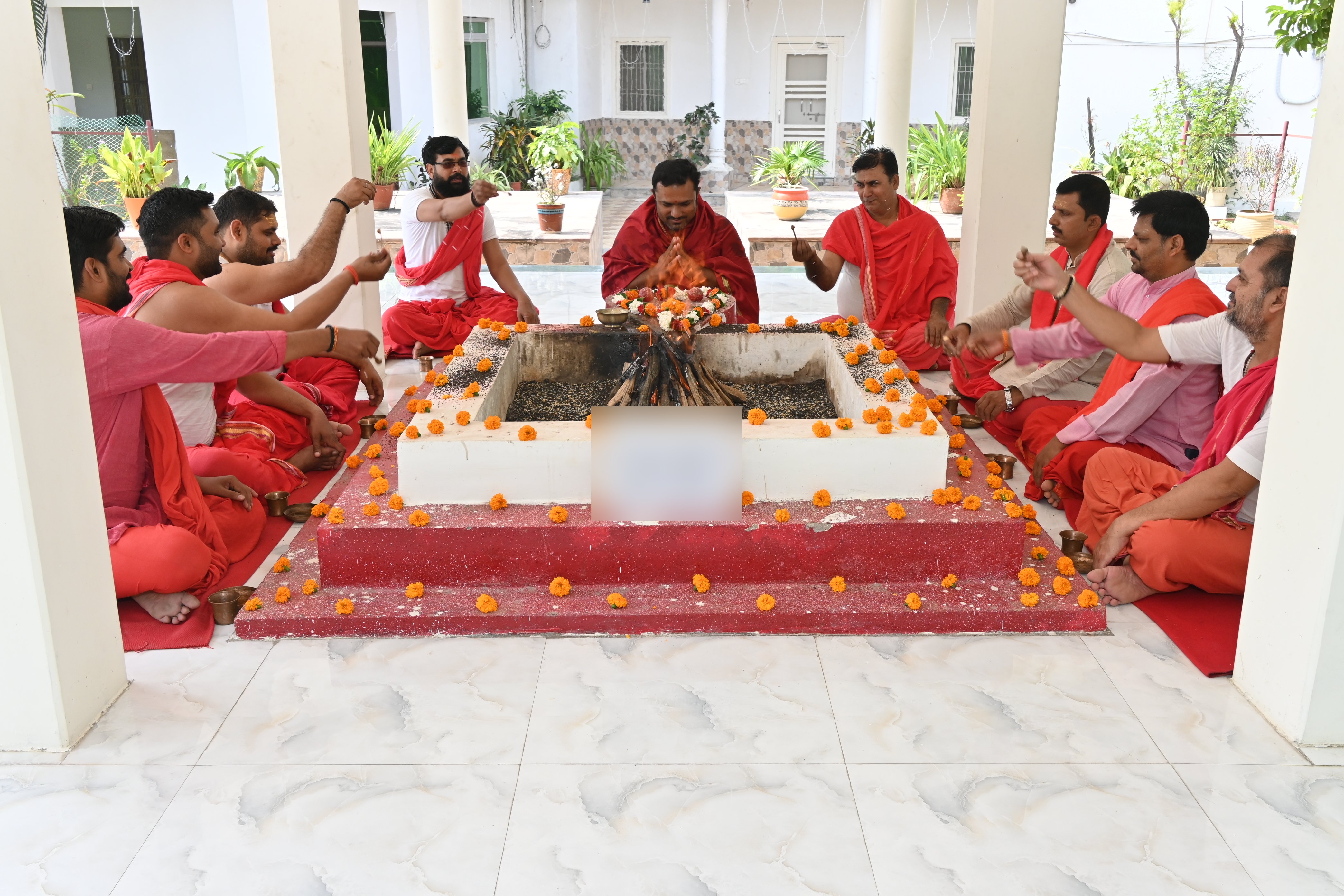 Priests offering oblations into the sacred fire during the Navratri havan at the ashram