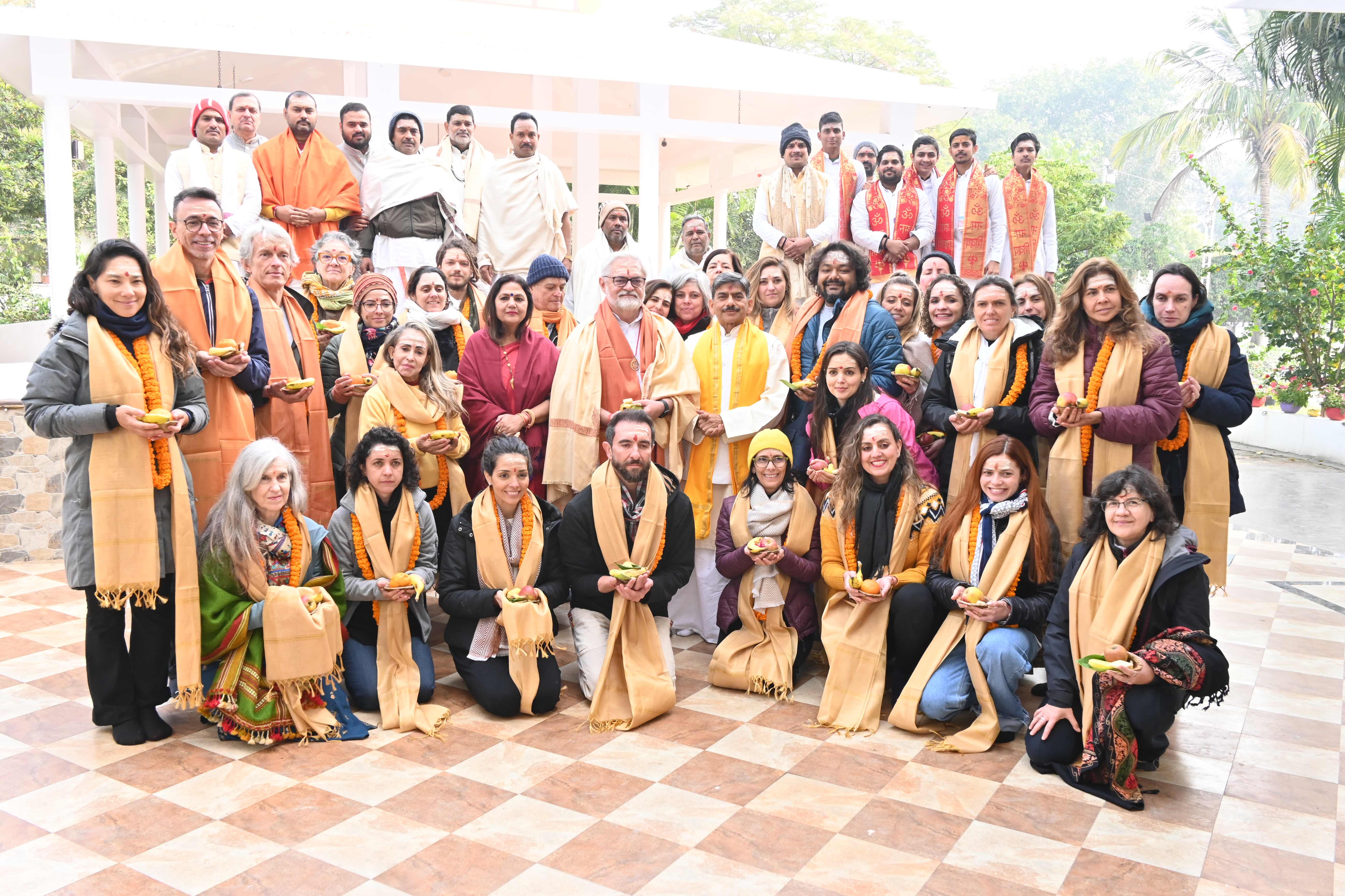 A group gathered in blessing during a Vedic ceremony at the ashram